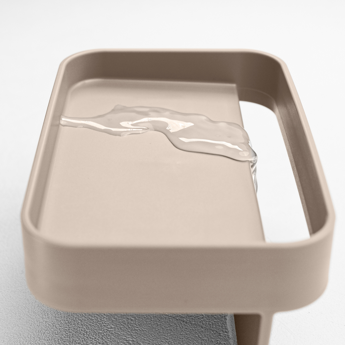 Blim+ Battigia Sponge Holder in taupe, close-up of the tray with water on it