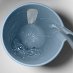Blim+ QB Carafe Small in blue, seen from above with water being poured in