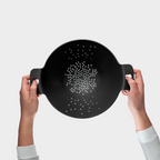 Blim+ Cosmo Colander Medium in black, held up in both hands, seen from the front