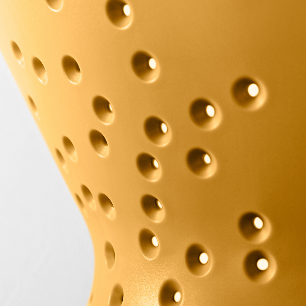 Blim+ Cosmo Colander Medium in yellow, close-up of the drainage holes