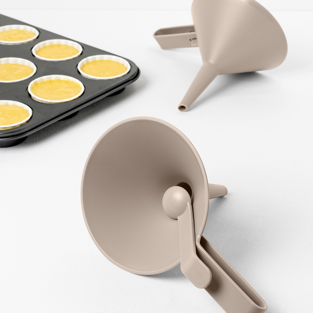 Blim+ Dolina Funnel in taupe, beside a muffin tray