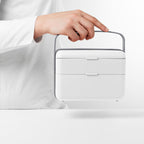 Blim+ Lunchbox Bauletto Medium in white, carried by the handle