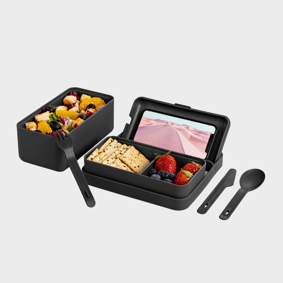 Blim+ Lunchbox Bauletto Medium in black, open with a phone, food and cutlery