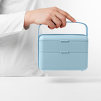 Blim+ Lunchbox Bauletto Medium in blue, carried by the handle