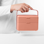 Blim+ Lunchbox Bauletto Medium in pink, carried by the handle