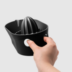 Blim+ Oblo' Juicer in black, held in a hand