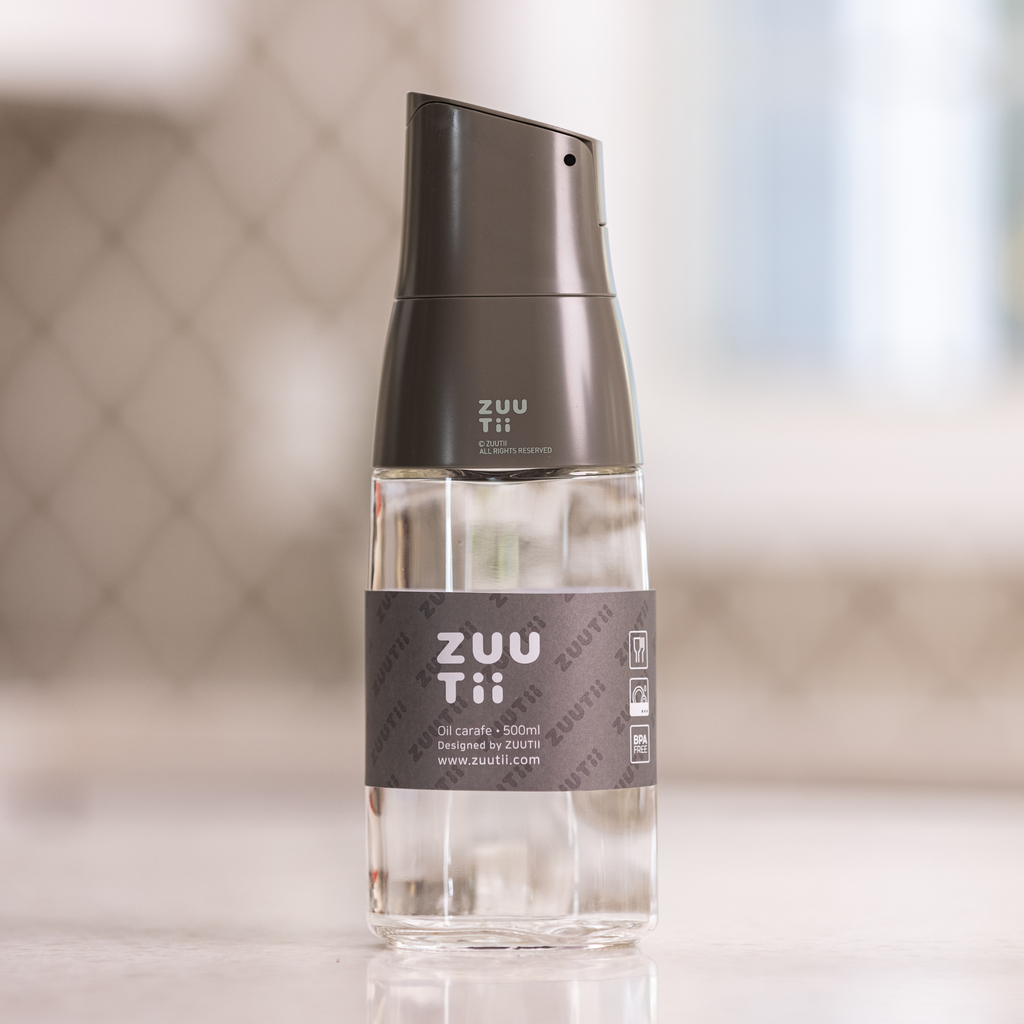 Zuutii Oil Dispenser in dark grey, front view on a kitchen counter