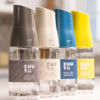 Zuutii Oil Dispenser in dark grey, cream, blue and yellow, close-up of the row