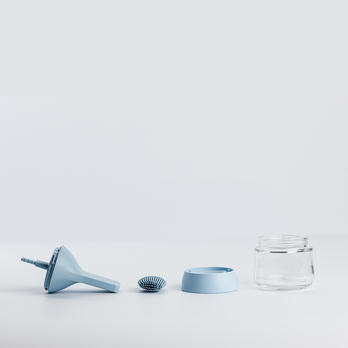 Zuutii Oil Dispenser with Brush in blue, separated into brush, lid, ring and glass jar