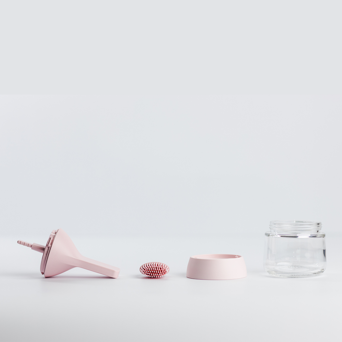 Zuutii Oil Dispenser with Brush in pink, separated into brush, lid, ring and glass jar