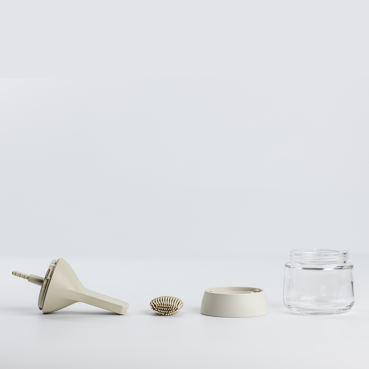 Zuutii Oil Dispenser with Brush in cream, separated into brush, lid, ring and glass jar