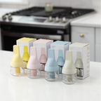 Zuutii Oil Dispenser with Brush in several colours beside boxed packaging on a kitchen counter