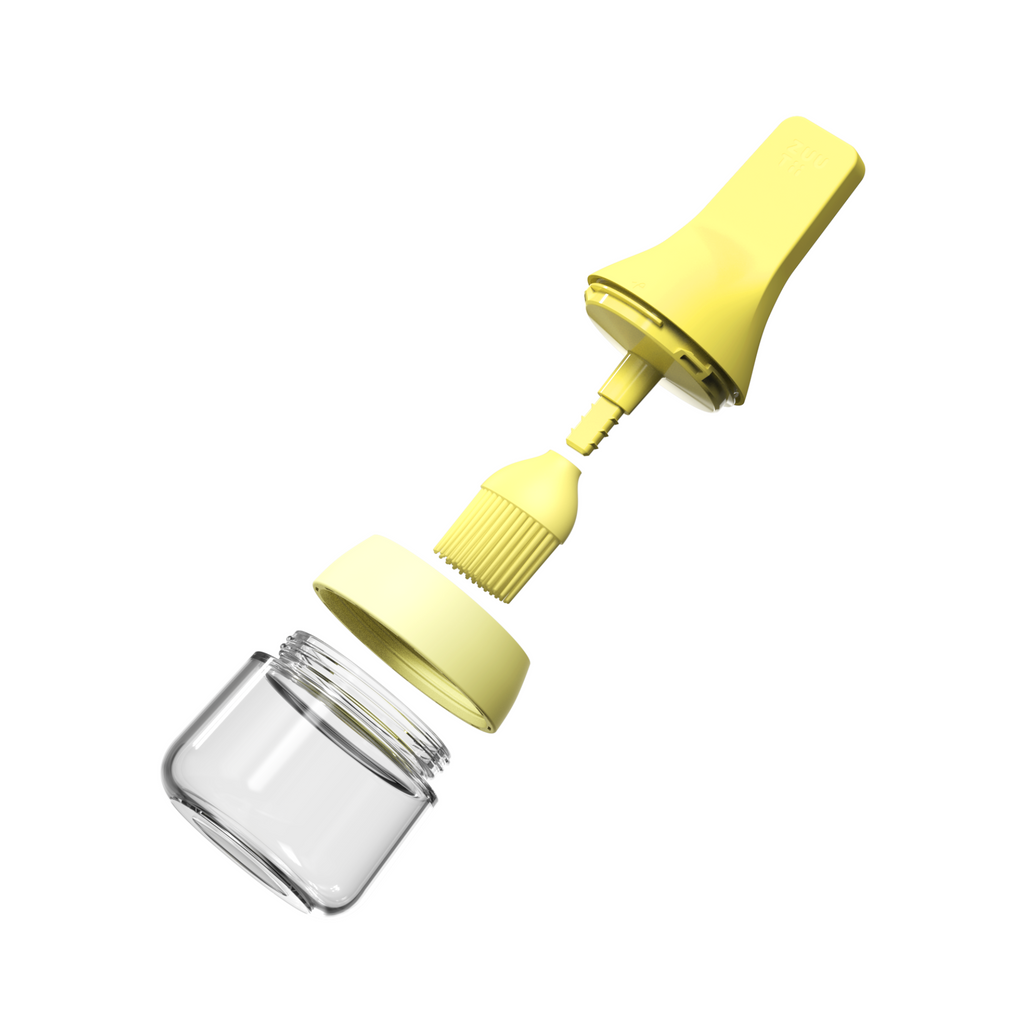 Zuutii Oil Dispenser with Brush in yellow, separated into brush lid and glass jar