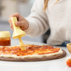 Zuutii Oil Dispenser with Brush in yellow, brushing oil onto a pizza base