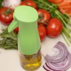 Zuutii Oil Sprayer in green beside tomatoes and onions