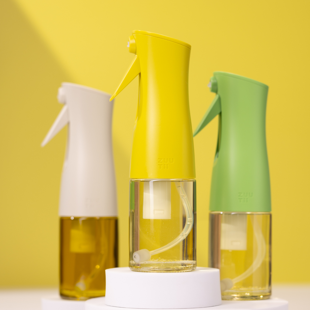 Zuutii Oil Sprayer in cream, yellow and green on a yellow background