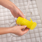 Zuutii Oil Sprayer in yellow, being washed