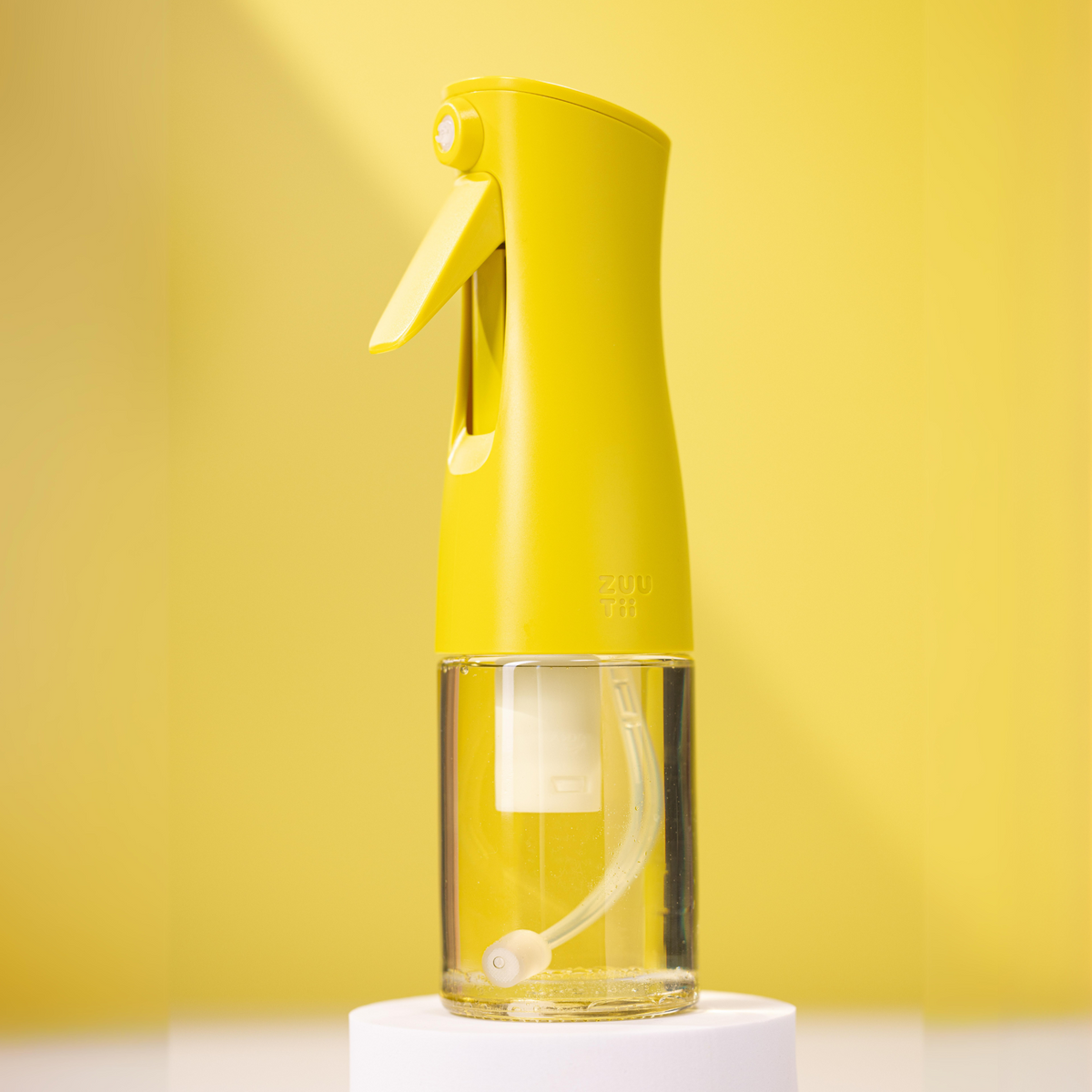 Zuutii Oil Sprayer in yellow on a yellow background
