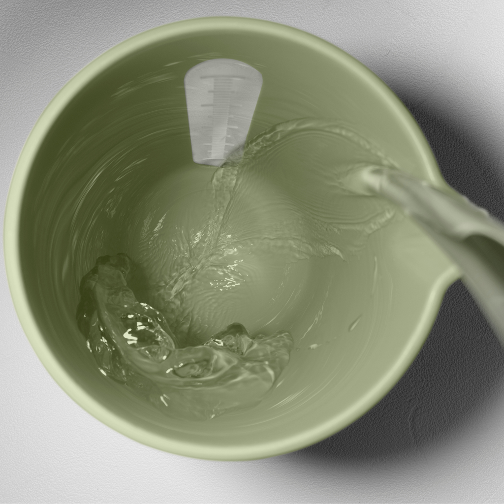 Blim+ QB Carafe in green, seen from above with water being poured in