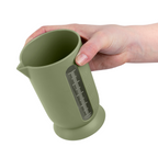 Blim+ QB Carafe Small in green, held in a hand
