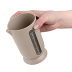 Blim+ QB Carafe Small in taupe, held in a hand