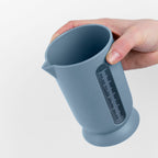 Blim+ UFO Juicer with QB Carafe in blue, carafe held in a hand