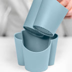 Blim+ Gocciolo Cutlery Drainer in blue, with the top part being lifted by hand