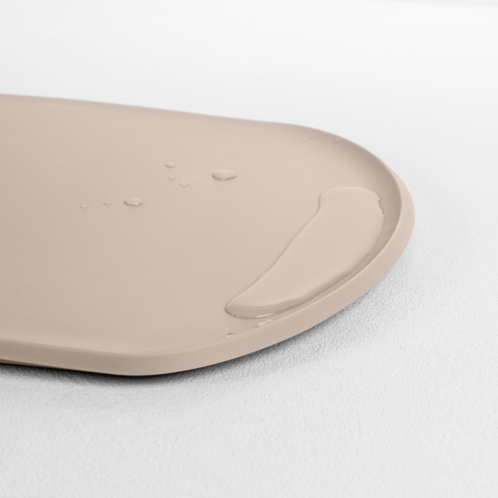 Blim+ Skateboard Chopping Board Medium in taupe, angled view of the raised edge