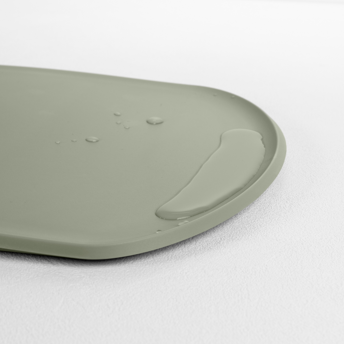 Blim+ Skateboard Chopping Board Medium in green, angled view of the raised edge