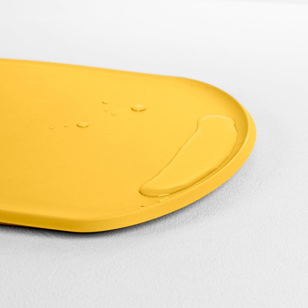 Blim+ Skateboard Chopping Board Medium in yellow, angled view of the raised edge