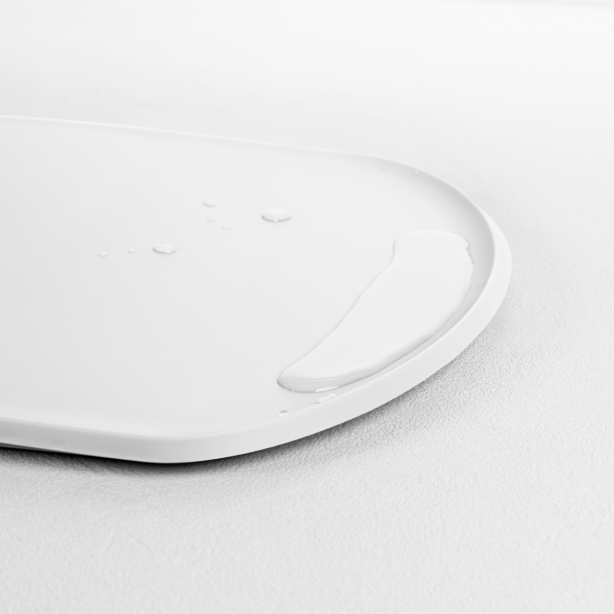 Blim+ Skateboard Chopping Board Medium in white, angled view of the raised edge