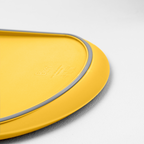 Blim+ Skateboard Chopping Board Medium in yellow, close-up of the grey silicone edge