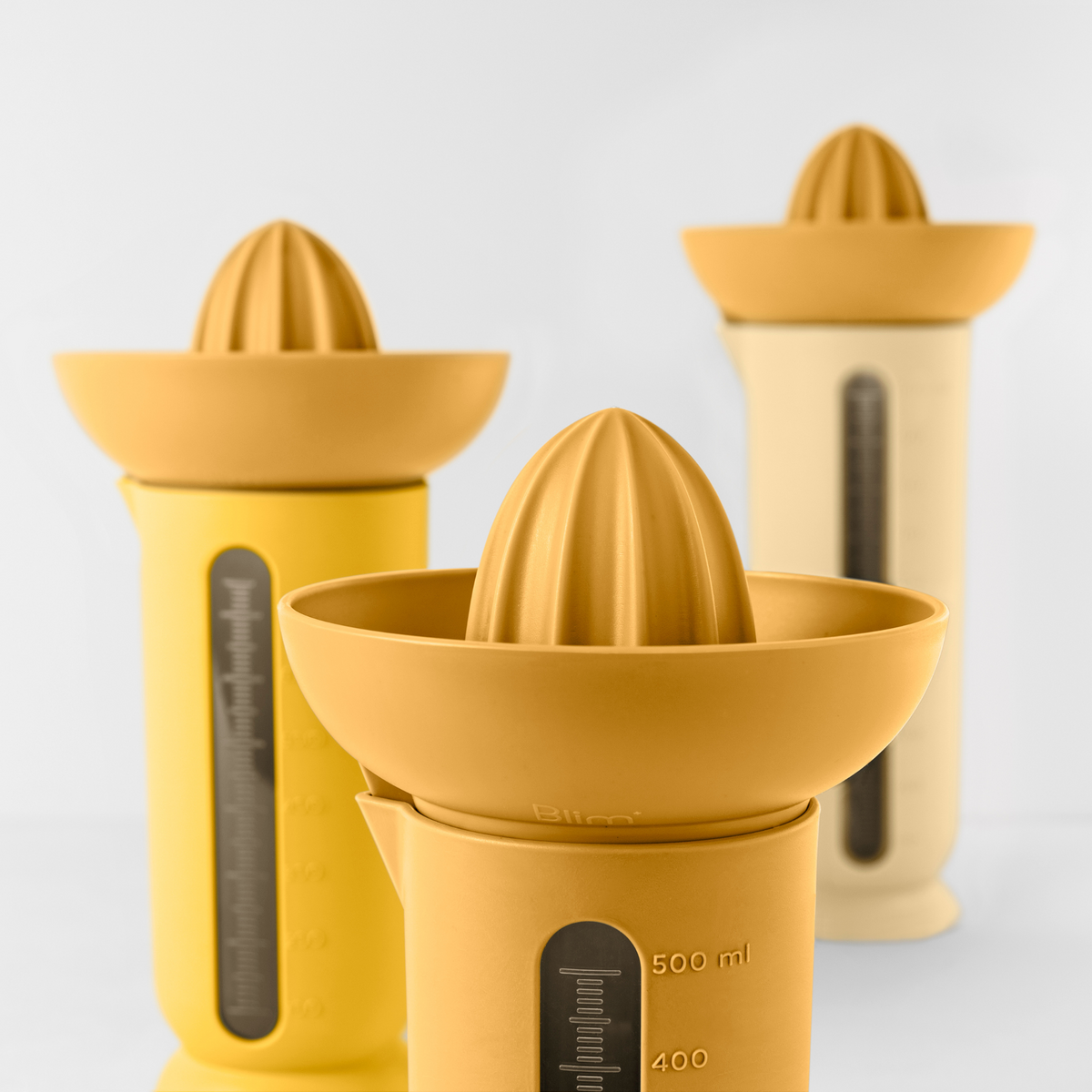Blim+ UFO Juicer with QB Carafe in yellow, with juicer and carafes in different sizes