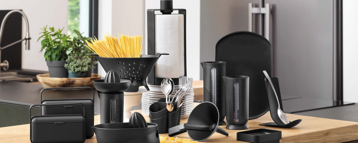 Black kitchen tools and storage containers on a kitchen counter